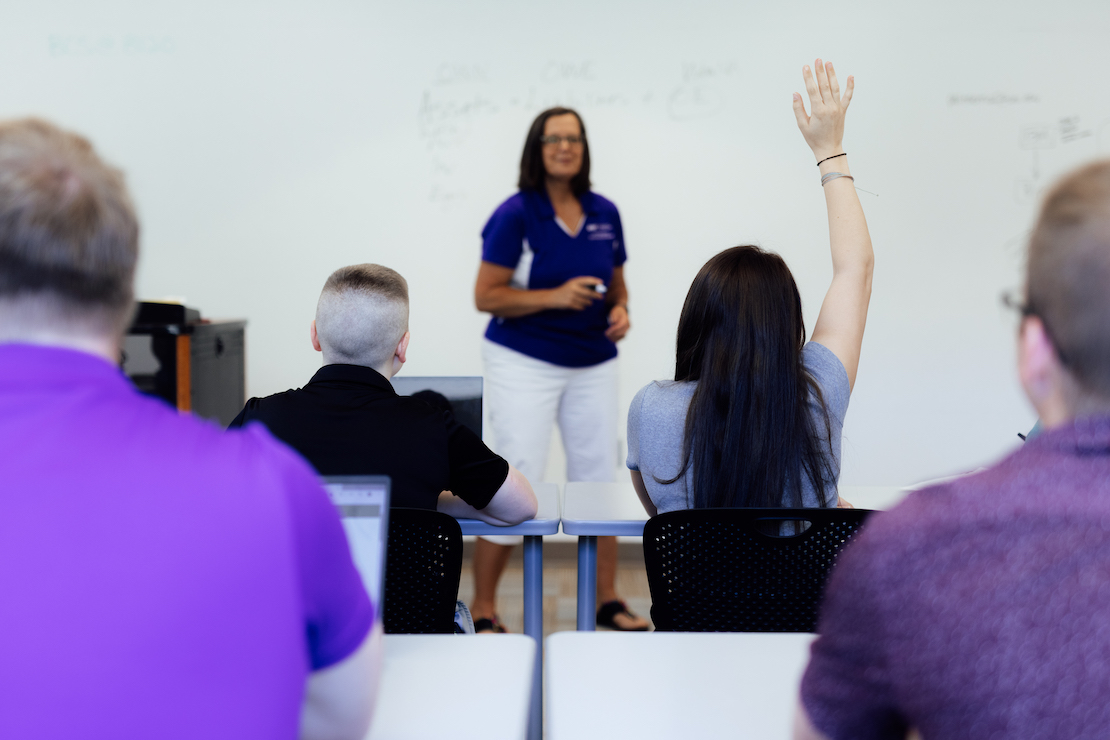 Woman raising her hand in a training session