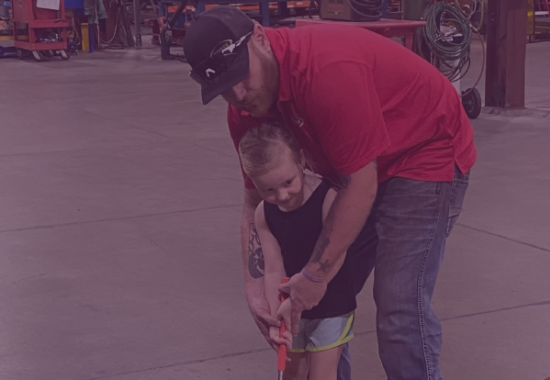 Man with child playing mini-golf